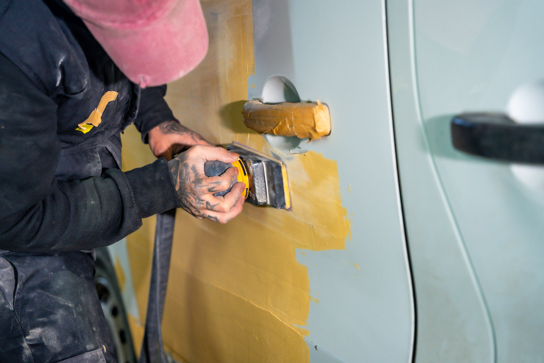 Technician applying tint to car window